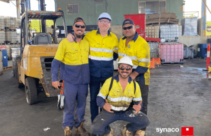 AusReo team members posing in front of froklift